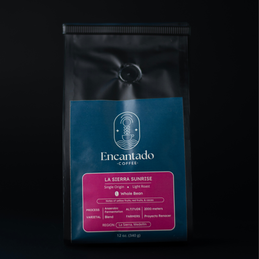 Bag of La Sierra Sunrise Light Roast Colombian coffee with a black background and blue and fuchsia label with the Encantado Coffee logo